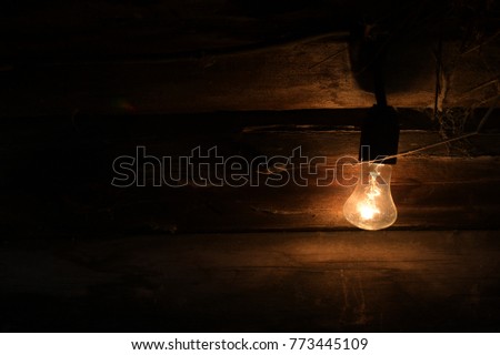 old light bulb glowing in dark