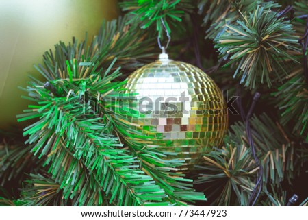 Disco Ball Sparkling Macro Closeup on Green Branch of Christmas Tree as Xmas Decorative Baubles concept of Christmas Festive Celebration Background or Holidays Abstract Wallpaper Banner Vintage Tone