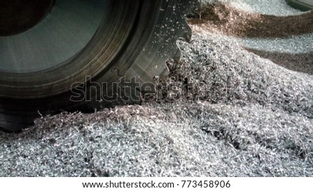 The metal cutting blade is very dangerous while working have a high rotation, Hazard work. This picture the cutting blade cut the aluminium you can see the aluminium powder. 