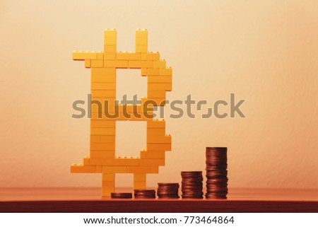 bitcoin symbol b made with brick toys and coins