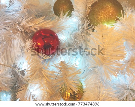 Red ball and glitter gold ball on the white christmas tree for warm festival