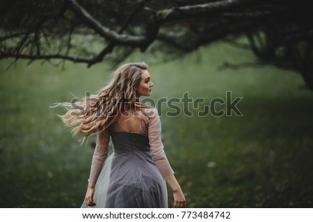 The beautiful lady walking near trees Royalty-Free Stock Photo #773484742