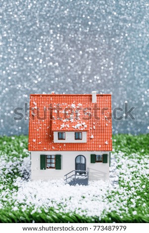 Picture of toy house with falling snow