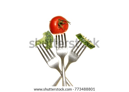 fork with tomato broccoli and cucumber no people stock photo