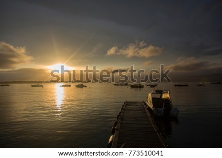 Low light photography - Sunrise view from the jetty with sun reflections on water. Lombok, Inonesia