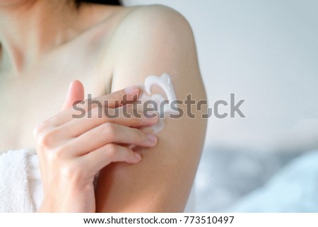 Woman applying moisturizing cream on Arm Royalty-Free Stock Photo #773510497