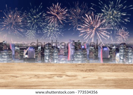 Desk of free space and new year time background with fireworks and city at night. 