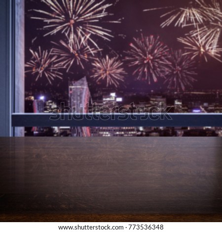 Table background of free space for your decoration and window background with fireworks at new year time 