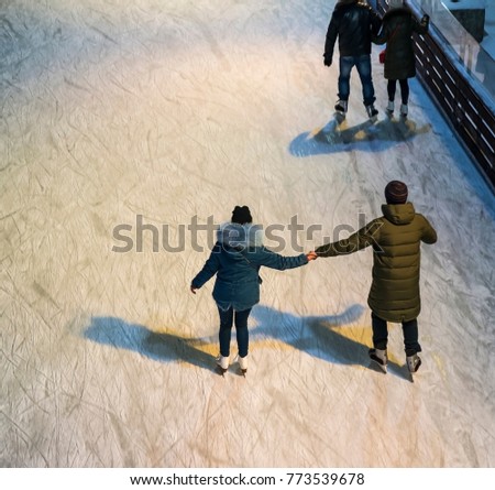 Skating rink, ice skating, a man and a woman skate Royalty-Free Stock Photo #773539678