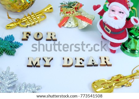 Merry Christmas Card "For my Dear" letter , picture show Santa Claus doll,gold bell , trumpet , guitar and the star with white background color.