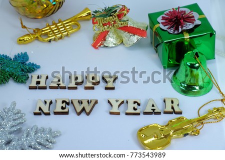 Merry Christmas card which picture show Happy New Year letter , gold bell , trumpet , guitar and the star with white background color.