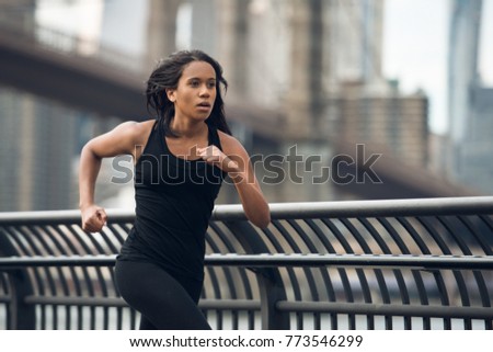African american woman running in New York City at the morning