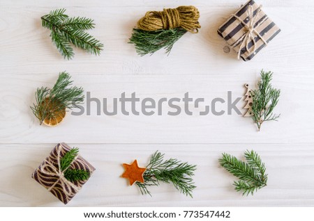 Christmas gifts on a white wooden background with sprigs of spruce, Christmas tree. New Year gifts