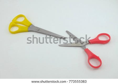 Yellow and red Scissors sharp on white background isolate