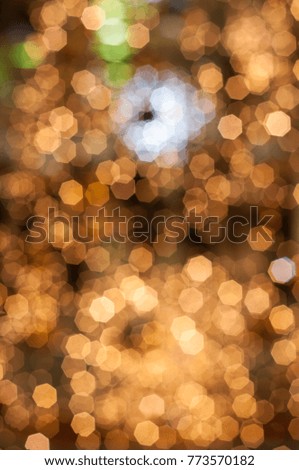 Christmas holiday festive glittering defocused golden background with bokeh lights