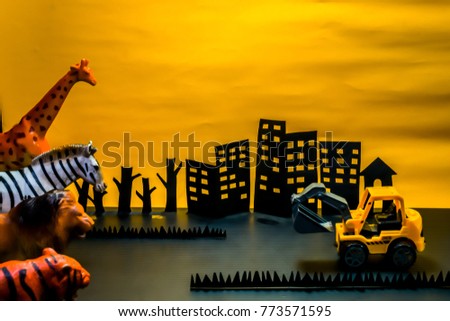 Paper cutting hand mead, Animals and wheel excavator on yellow back ground.  conservation forests and wildlife concept. Royalty-Free Stock Photo #773571595