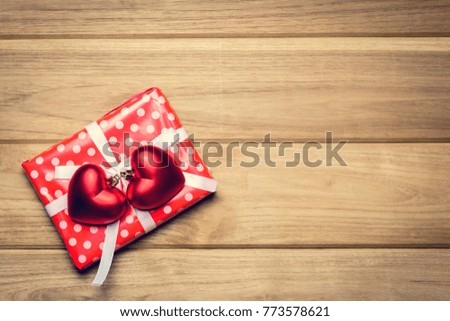 Top view red pink heart and gift box on old wooden table and valentine day