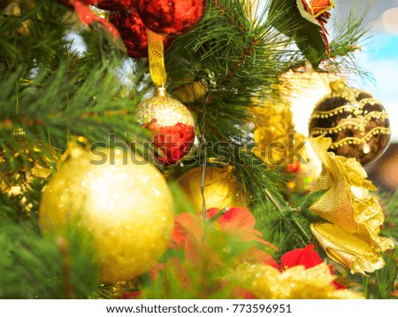 Bright and beautifully decorated with toys Christmas tree against shiny illuminated soft focused background. Christmas and New Year concept.