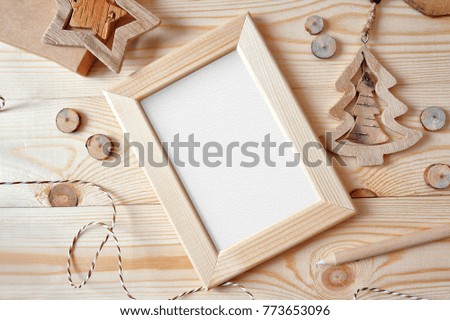 Christmas background with a wooden frame and a star and tree. Flat lay, top view photo mockup, with space for your text.