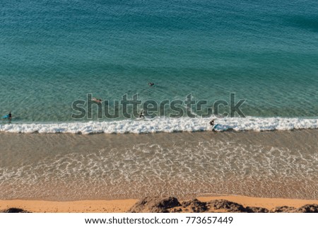 Surfers in Turquoise Water. Atlantic Ocean in Fuerteventura golden sand beach, Canary Islands. Shot from above.