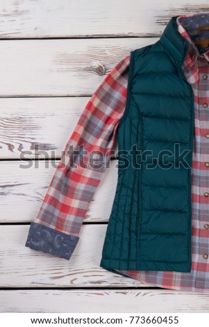 Combination of vest and shirt. Plaid pattern of flannel fabric. Warm outfit idea for outing.