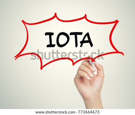 female hand writing iota message in cartoon balloon with marker on transparent board
