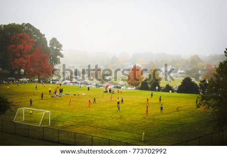 Early morning soccer game in the fog.