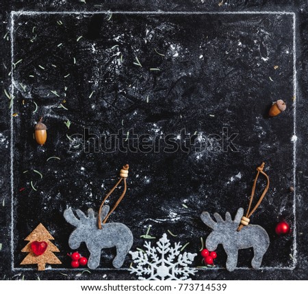 Winter plot. two flat moose and silhouette of a Christmas tree in a white frame on a dark background
