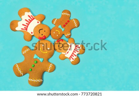 Gingerbread family on the blue background. Christmas and new year concept, copy space for text.
