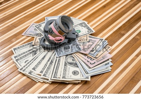 handcuffs with dollar bills on desk. close up Royalty-Free Stock Photo #773723656