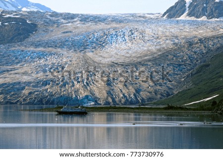 Ship navigating closely to a glacier in Glacier Bay Alaska  Royalty-Free Stock Photo #773730976