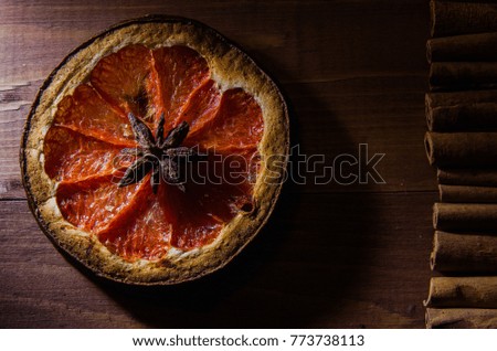 Dried grapefruit with cinnamon and anise  on  wood