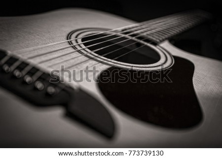 Black and White rose up of an acoustic guitar Royalty-Free Stock Photo #773739130