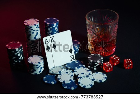 Cards of poker player. On the table are chips and a glass of cocktail with whiskey. Cards - Ace and King