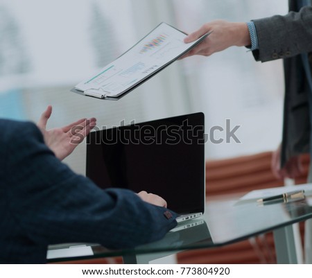 Businessman his colleague giving contract to read and sign