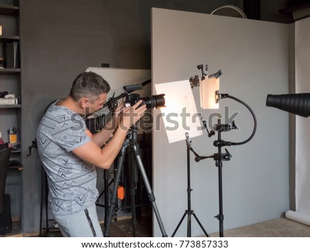 a young photographer work in photo studio. unintended photography