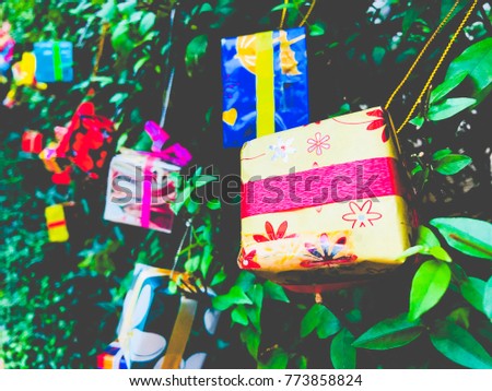Concept Merry Christmas and Happy New Year. Colourful gift boxes and decoration for Christmas on a big tree background. for Christmas or New Year congratulation card, flyer, banner (selective focus)