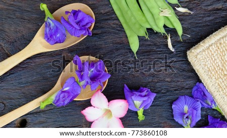 Butterfly Pea Flower in ladle placed on the old wooden background.