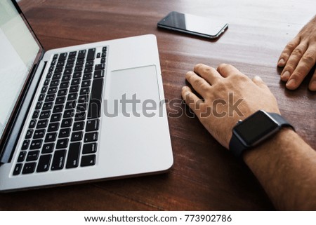 Concept - Online Work, Office, Hands with Laptop and Phone on the Wooden Desk