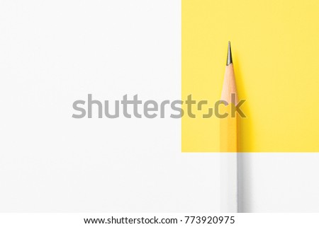 Minimalist template with copy space by top view close up macro photo of wooden yellow pencil isolated on white texture paper and combine with yellow graphic.Flash light made smooth shadow from pencil. Royalty-Free Stock Photo #773920975