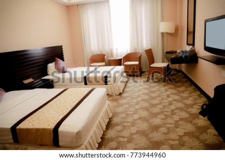 A hotel room, bedroom with two beds, curtain, lighting front view at the day in holiday Royalty-Free Stock Photo #773944960