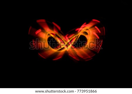 Lightpainting, red and orange infinity sign on black background