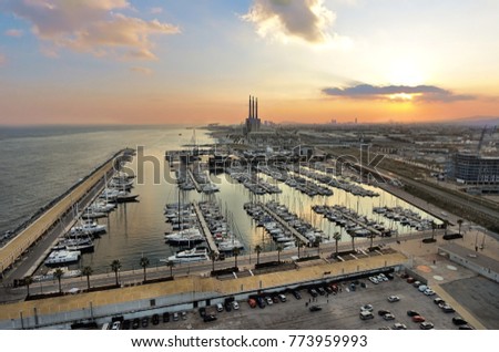 Badalona from drone, Aerial photography at sunset, east of Barcelona. Famous three pipes, a sea port and a yacht club are visible. Royalty-Free Stock Photo #773959993