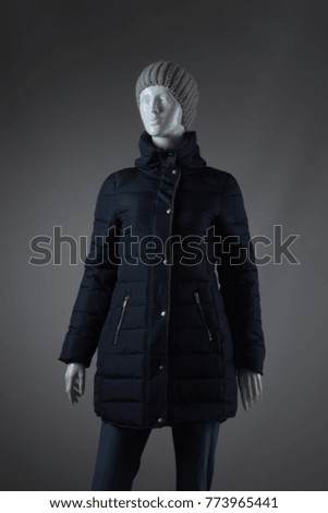 Women's winter jacket and a hat on a mannequin