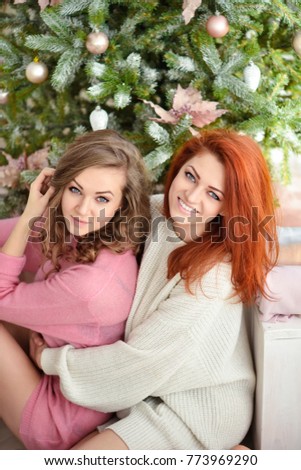 Young beautiful women near christmas trees. New year concept.