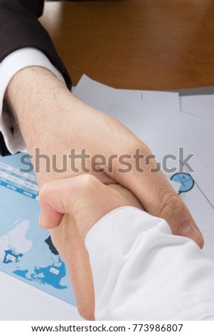 contract is signed and the salespeople shake hands