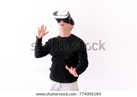 Handsome man wearing and playing virtual reality on isolated white background. Boy action in virtual reality helmet. VR glasses. VR Box, VR headset. Young business man at office and using Vr Box.