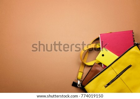 Bright colored women's accessories on a brown background. Lay flat, top view