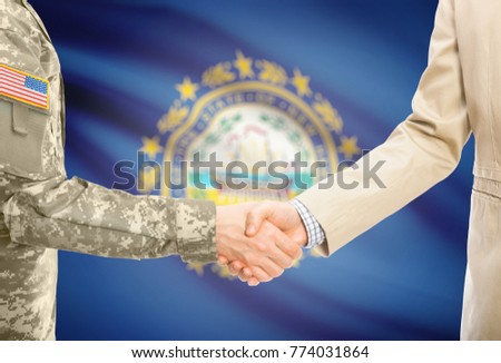 American soldier in uniform and civil man in suit shaking hands with certain USA state flag on background - New Hampshire