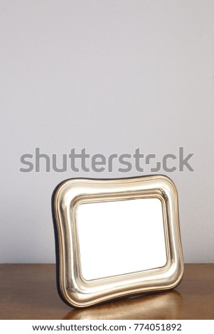 silver frame for memories photos on a wooden shelf
